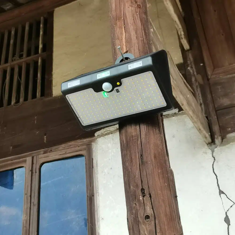 solar light with movement sensor hanging on a wooden pole