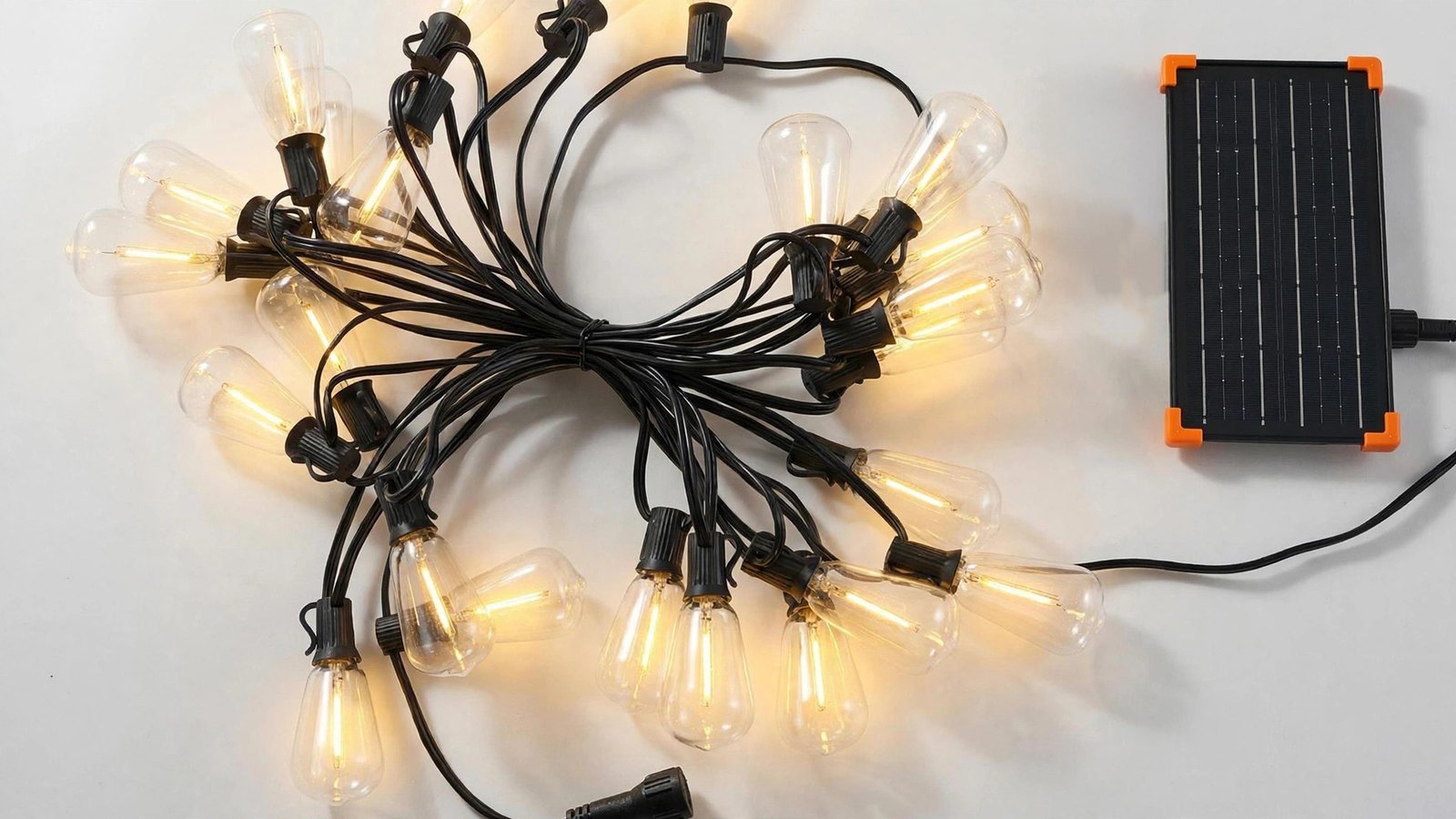 Couleelight ST38 solar string lights glowing warm white beside a rectangular solar panel with orange corner guards